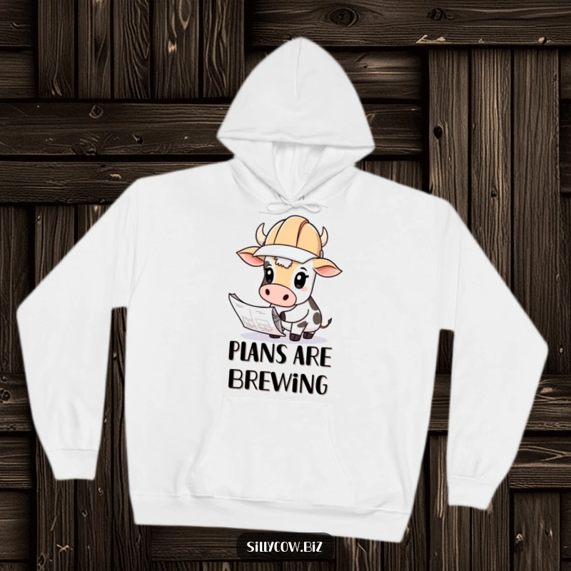 Funny Cow Hoodie: Cow wearing a hard hat looks curiously at blueprints, cozy and thoughtful.
